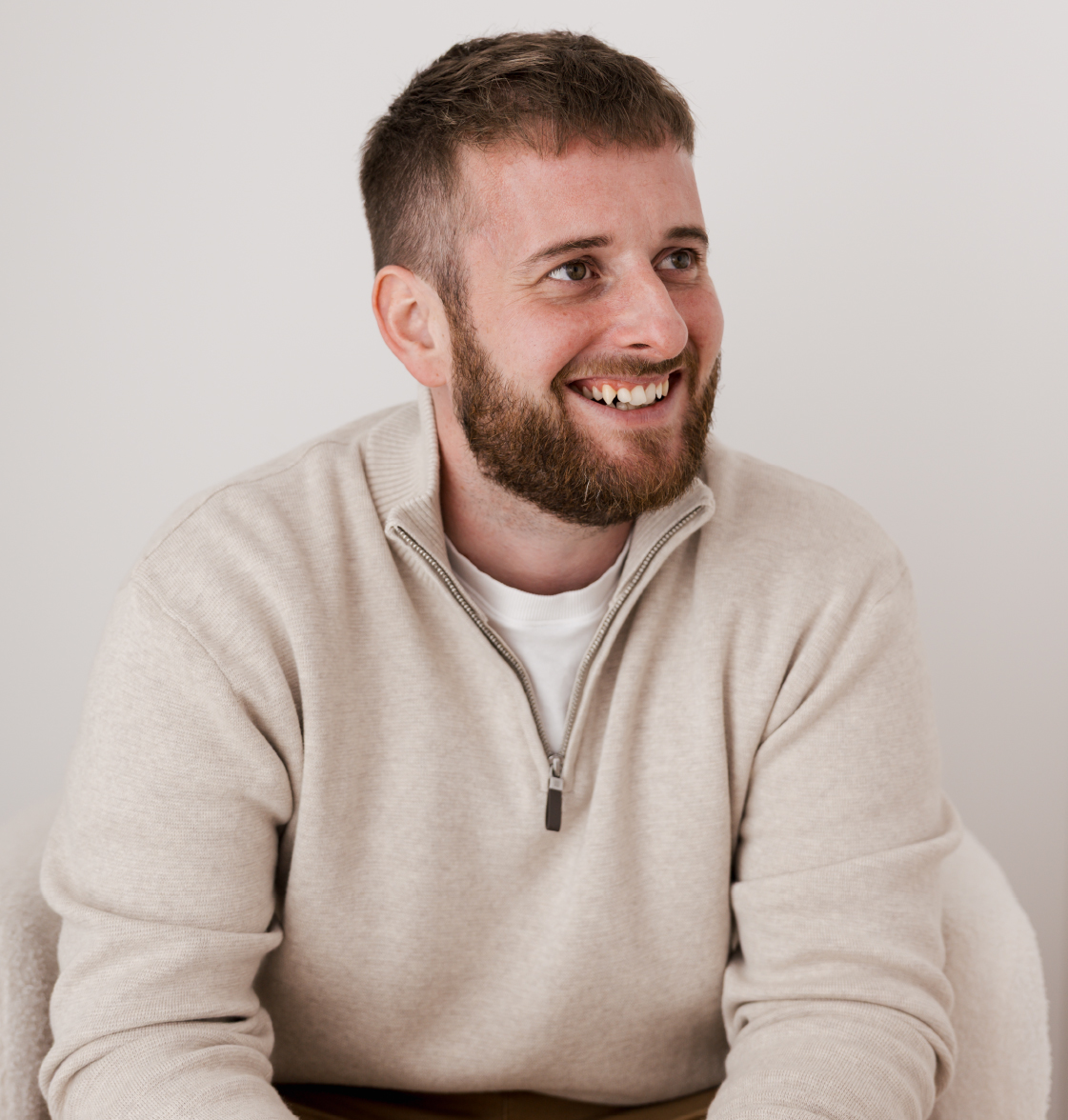 Toby Bigmore smiling in a cream jumper